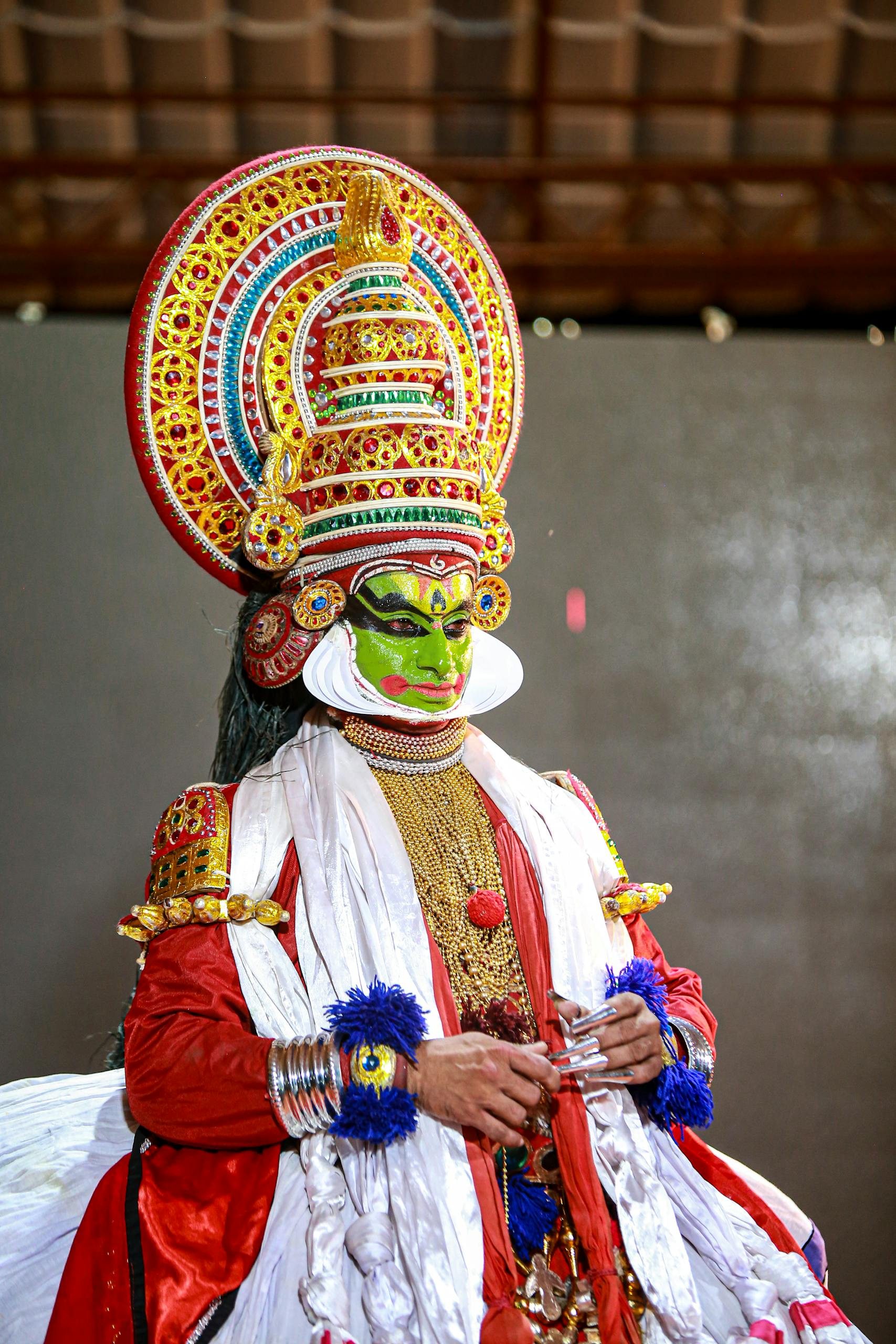 A vibrant Kathakali performer in traditional costume and makeup during a cultural event in Kerala, India. Onam 2025