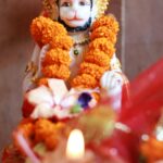 Close-up of a sacred Hanuman statue adorned with garlands, capturing spiritual essence.