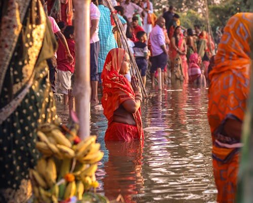 "Pitru Paksha ritual: devotee performing tarpan by the river during Pitru Paksha"पितृ पक्ष